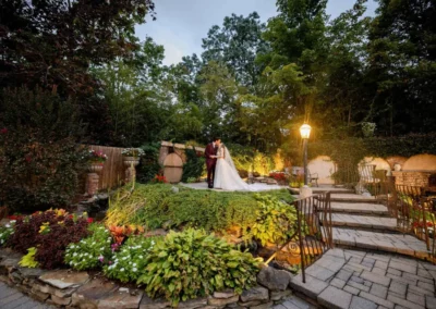 Bride and groom sitting on a bench in a rustic courtyard on their wedding day