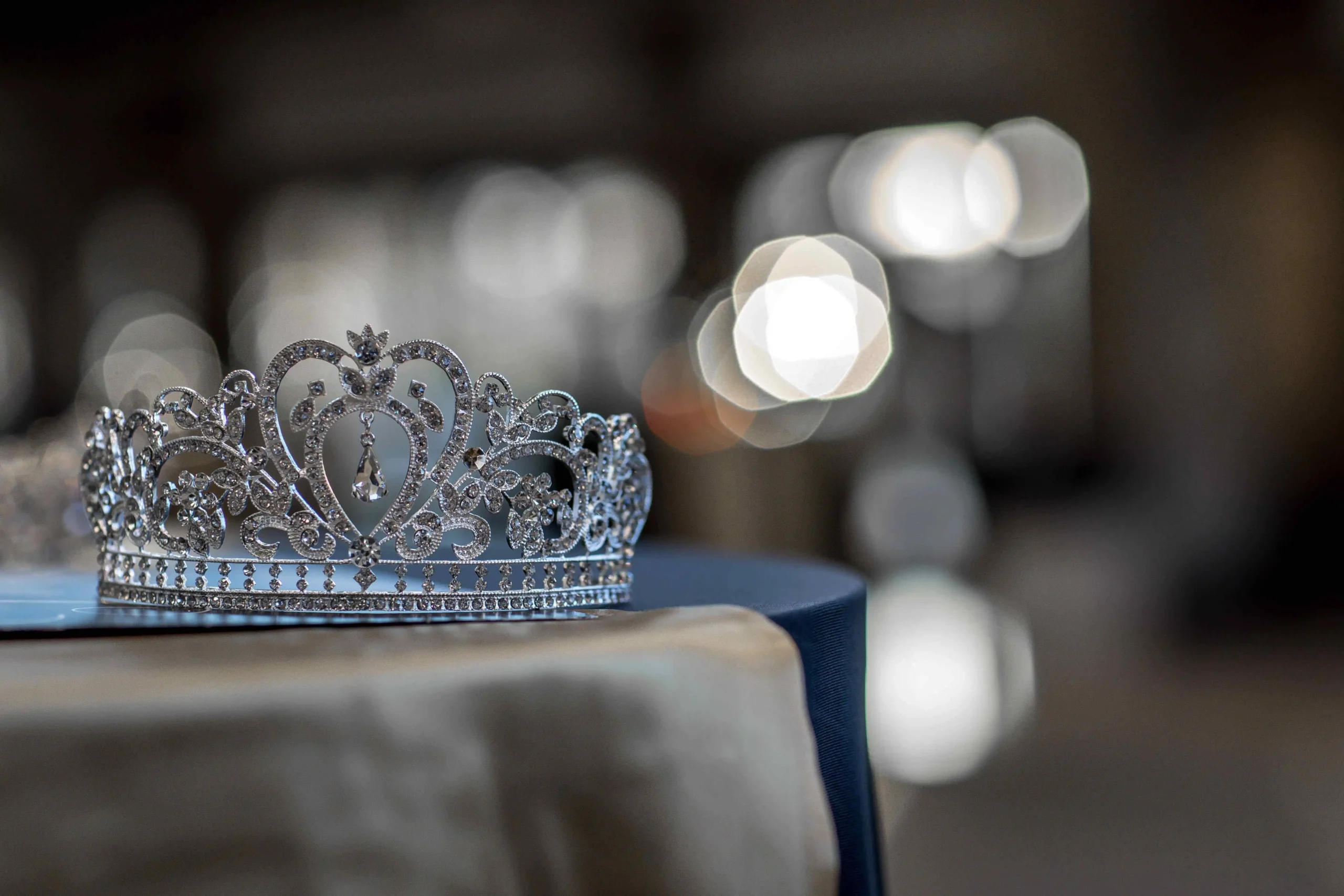 Elegant crown laying on a satin tablecloth