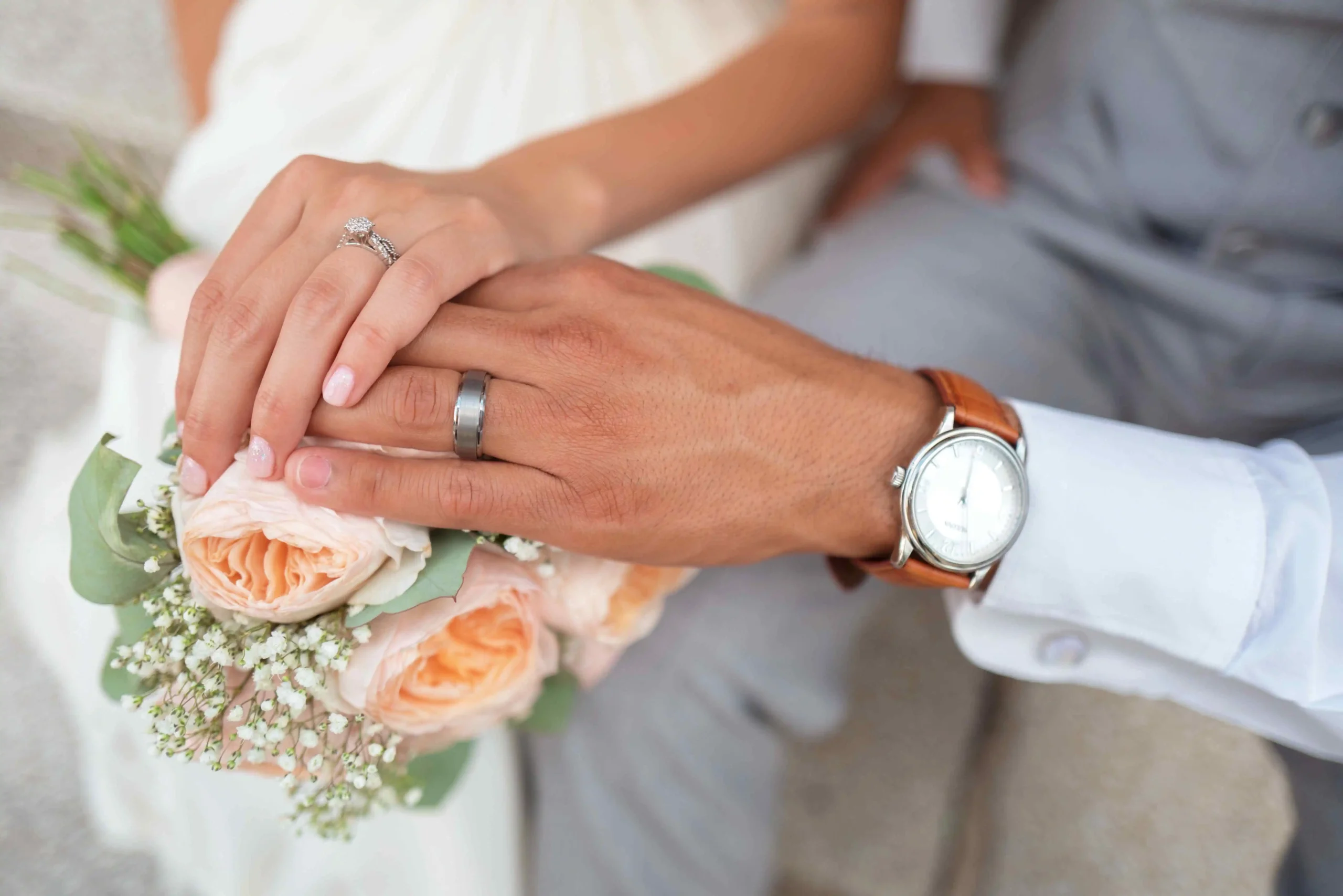  Clasped hands of bride and groom 
