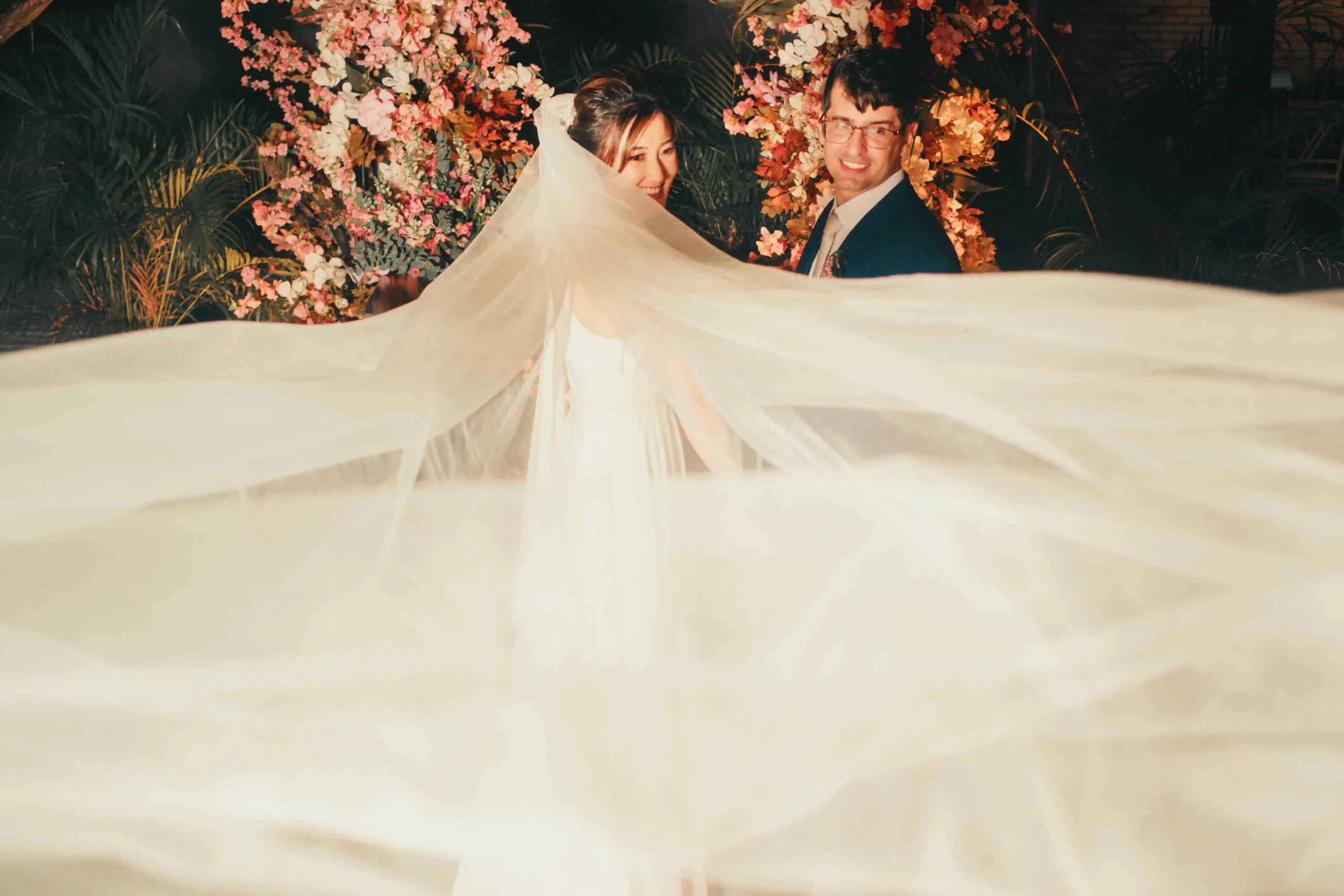Bride and groom sharing a kiss in the garden surrounded by fall foliage on their wedding day<br />
