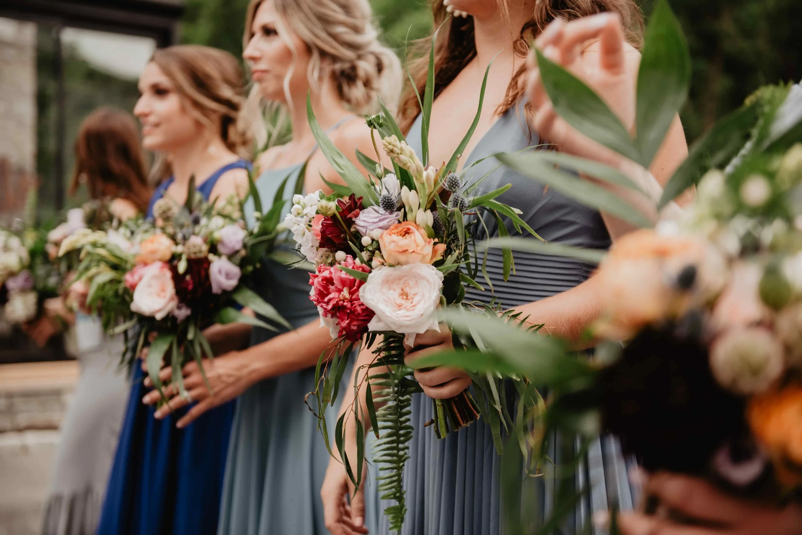 Row of bridesmaids holding bouquets