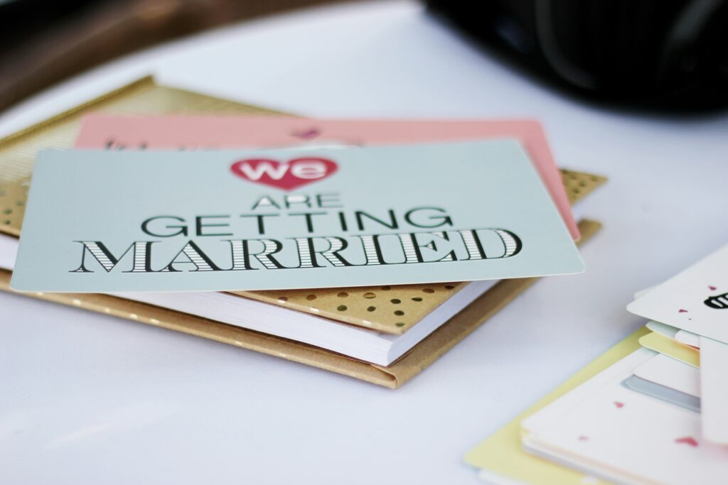 Wedding invitations on gold notebook.