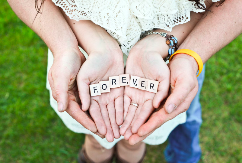 Couple’s hands with forever message